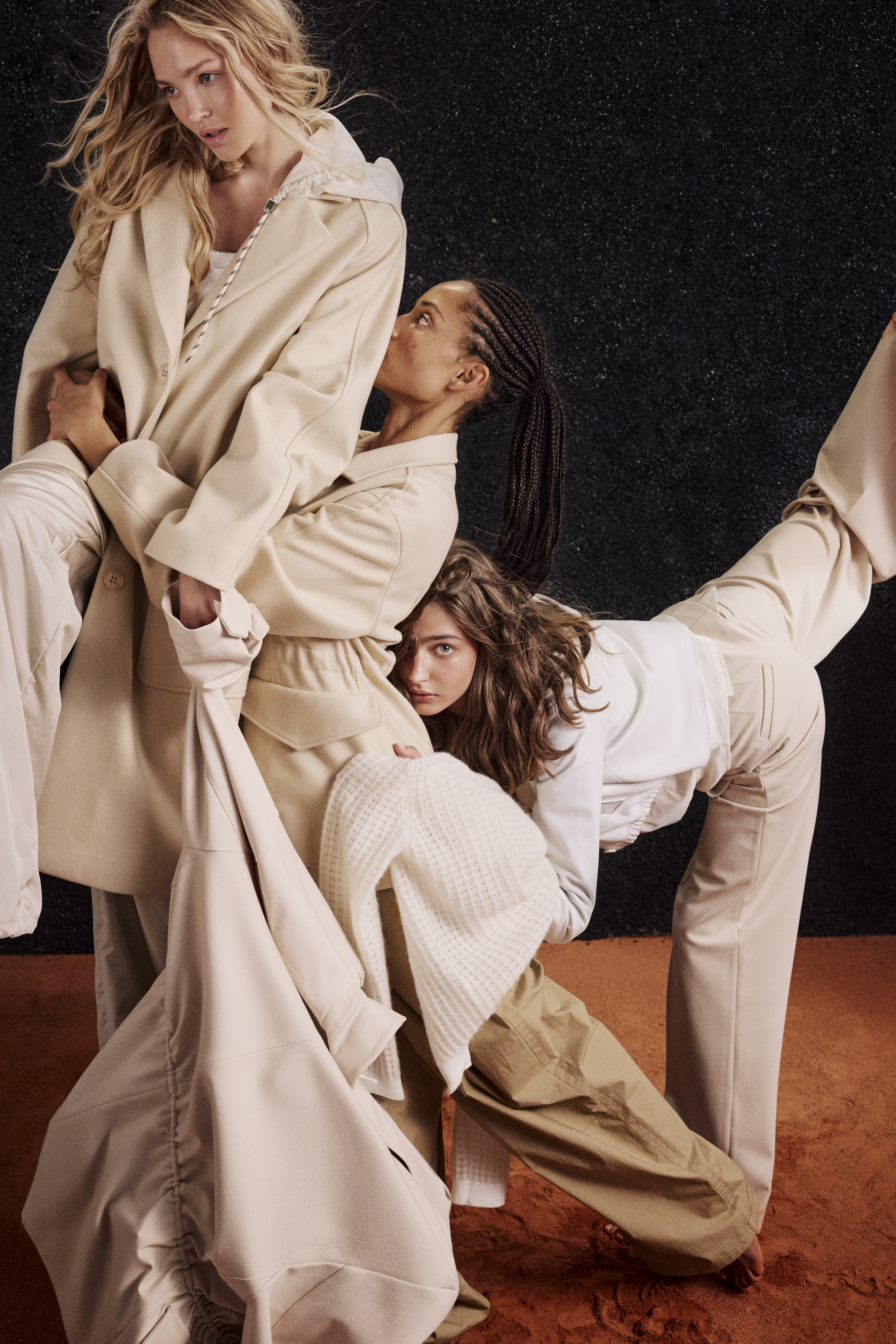 three women wearing white and beige clothes like coats and jackets and wideleg pants
